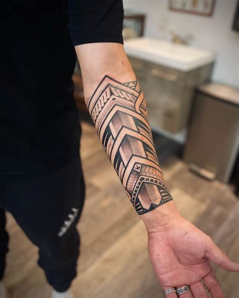 versace wrist tribal tattoos|forearm tribal tattoo.